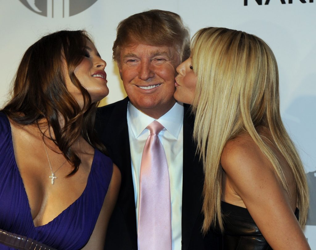 (FILES) This file photo taken on June 24, 2008 shows Melania Trump, Donald Trump and model Heidi Klum posing at party at the Park Avenue Plaza in New York June 23, 2008 to introduce the Trump International Hotel & Tower Dubai.  Donald Trump said on November 9, 2016 he would bind the nation's deep wounds and be a president "for all Americans," as he praised his defeated rival Hillary Clinton for her years of public service. / AFP / TIMOTHY A. CLARY