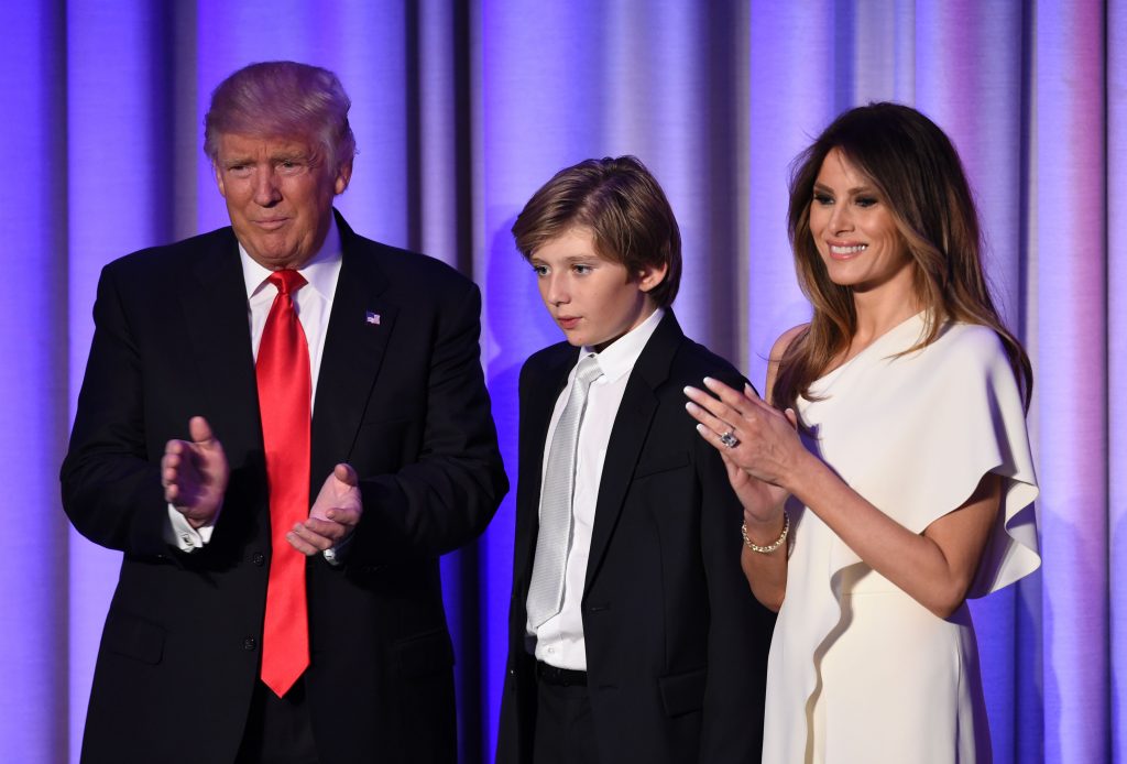 TOPSHOT - US President-elect Donald Trump arrives with his son Baron and wife Melania at the New York Hilton Midtown in New York on November 8, 2016.  Trump stunned America and the world Wednesday, riding a wave of populist resentment to defeat Hillary Clinton in the race to become the 45th president of the United States. / AFP / SAUL LOEB